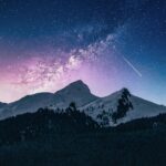 mountain range with stylized night sky, showing space and stars