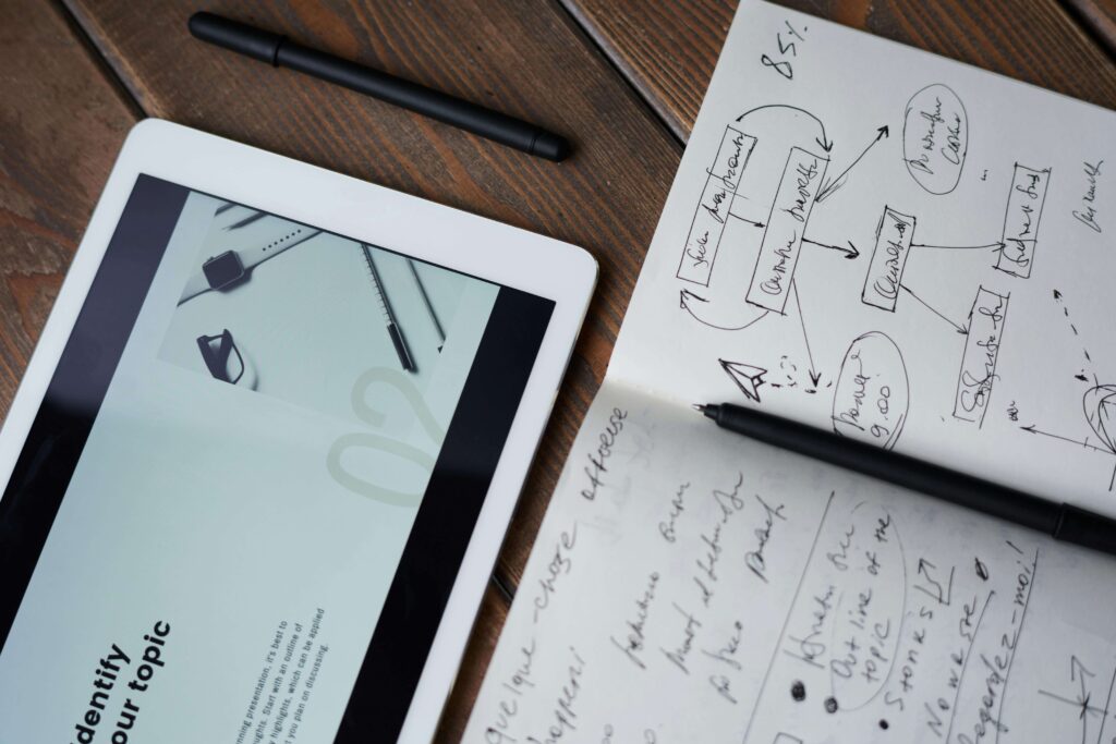 tablet above and an open notebook