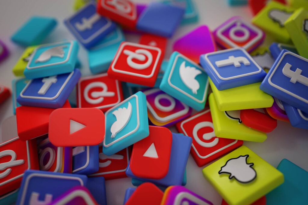 a pile of social media icon tiles, that include youtube, twitter, facebook, pintrest, and instagram